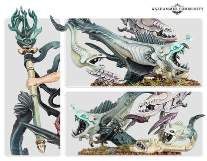 Warhammer miniature: Hand holds a staff beside several grotesque, sharp-toothed, multi-colored fish-like monsters on a base