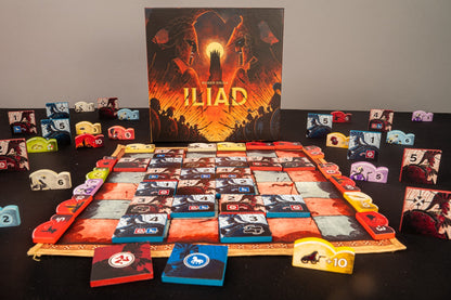 The Iliad board game by Reiner Knizia, featuring its box art, a central game board with tiles and many player tokens