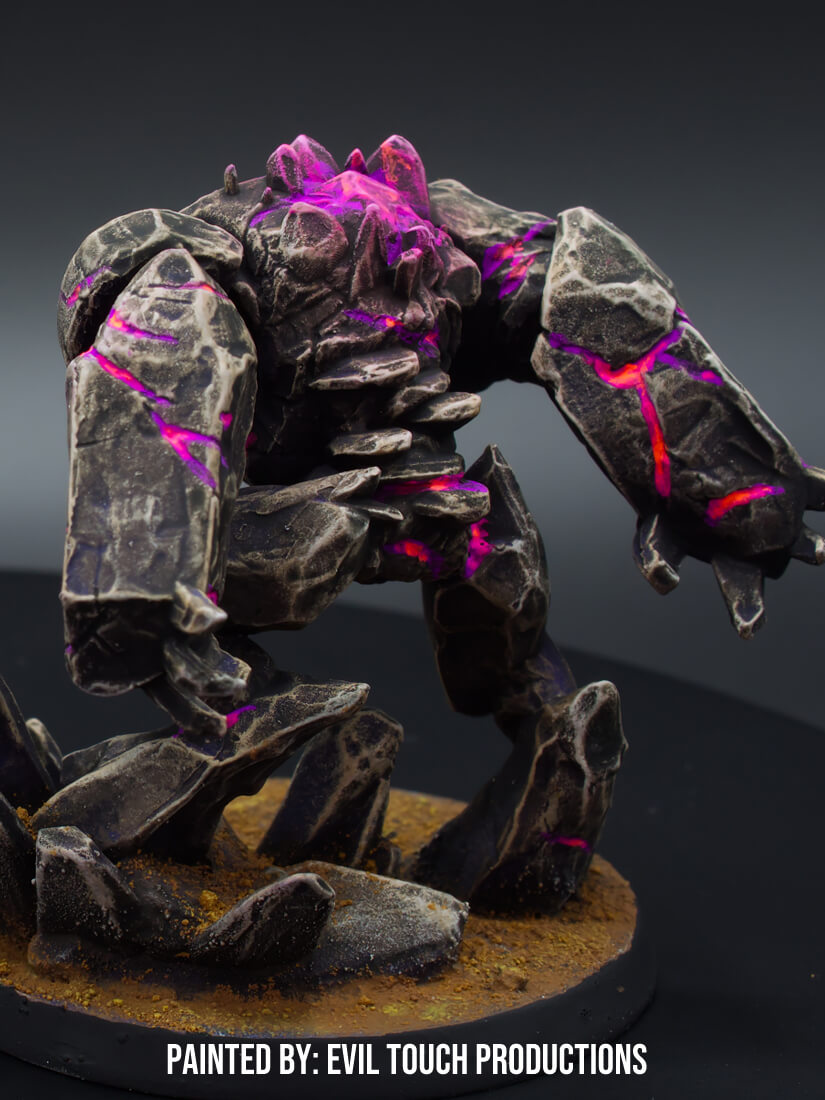 A fantasy golem miniature, made of dark rock with glowing purple lava cracks, standing on a textured base