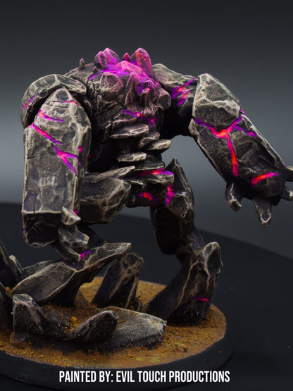 A fantasy golem miniature, made of dark rock with glowing purple lava cracks, standing on a textured base