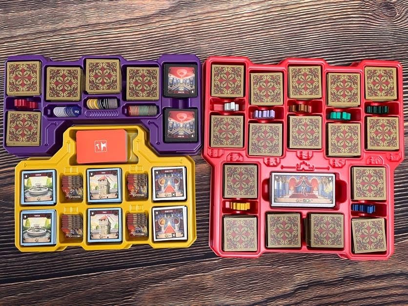 Two board game box organizers filled with game pieces and cards
