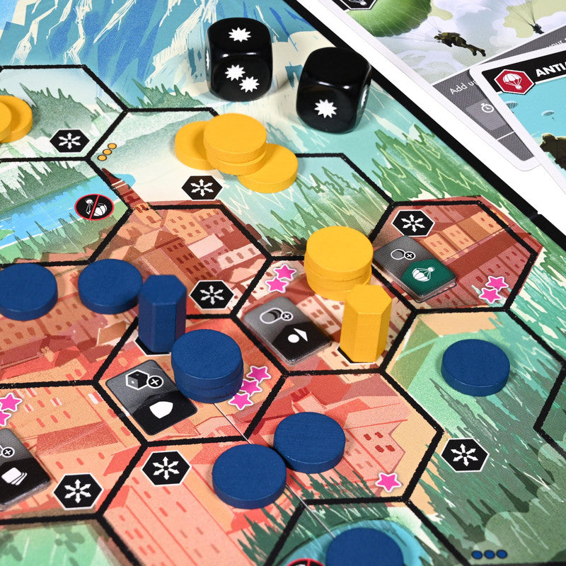 Close up of a game board showing blue and yellow pieces dice and cards with various icons
