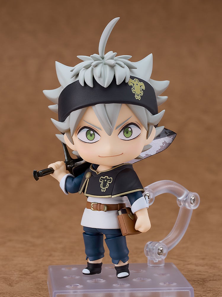 A smiling Nendoroid figure of Asta from Black Clover, with gray hair and green eyes, holding his Demon-Slayer Sword over his shoulder