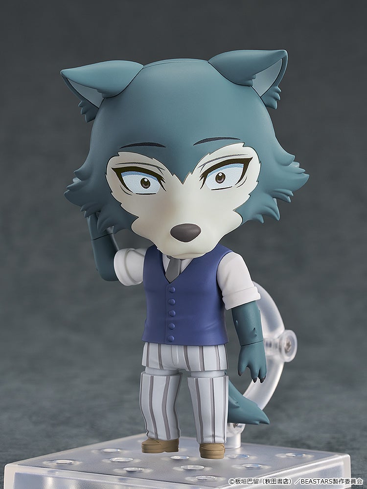 A Nendoroid of Legoshi, the blue-gray wolf from Beastars, in a vest and striped pants, standing with one hand raised