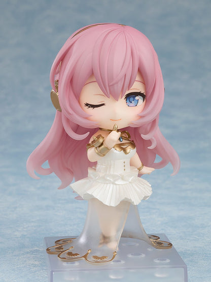 A Nendoroid figure with long pink hair, wearing a white and gold mermaid-style dress, winks and smiles while touching a gold accessory