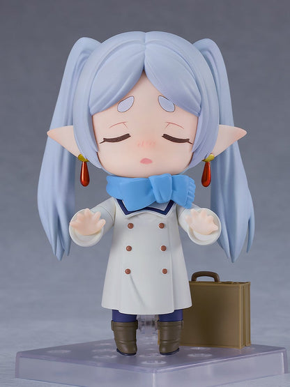 Good Smile Company Nendoroid Frieren Winter Clothes Version figure pale blue hair in pigtails white double-breasted coat blue scarf holding a brown suitcase