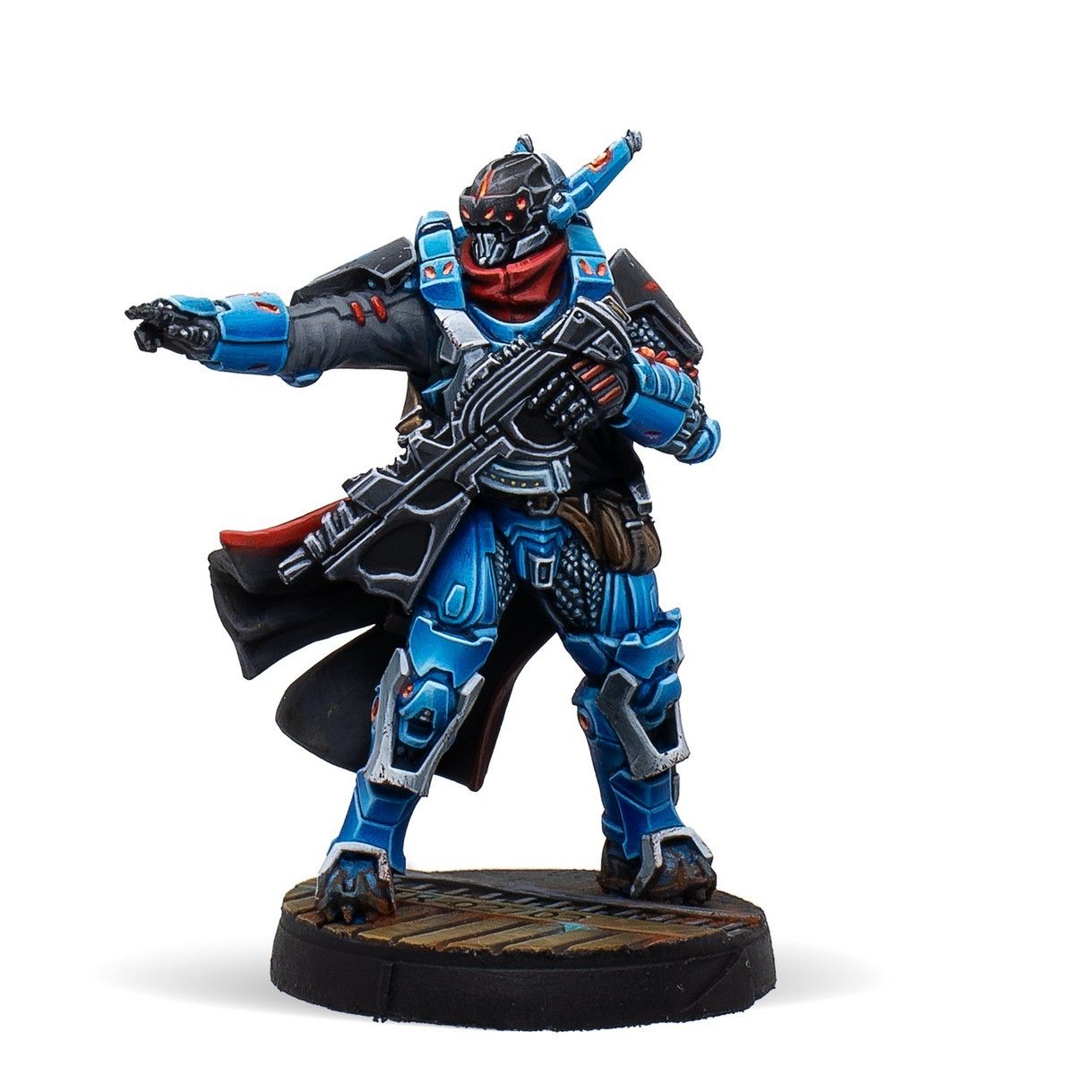Futuristic soldier miniature in blue armor, red scarf, and black coat, holding a rifle and pointing forward.