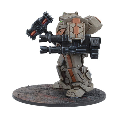 A beige and brown sci-fi mech miniature with two large guns, standing on a textured base.