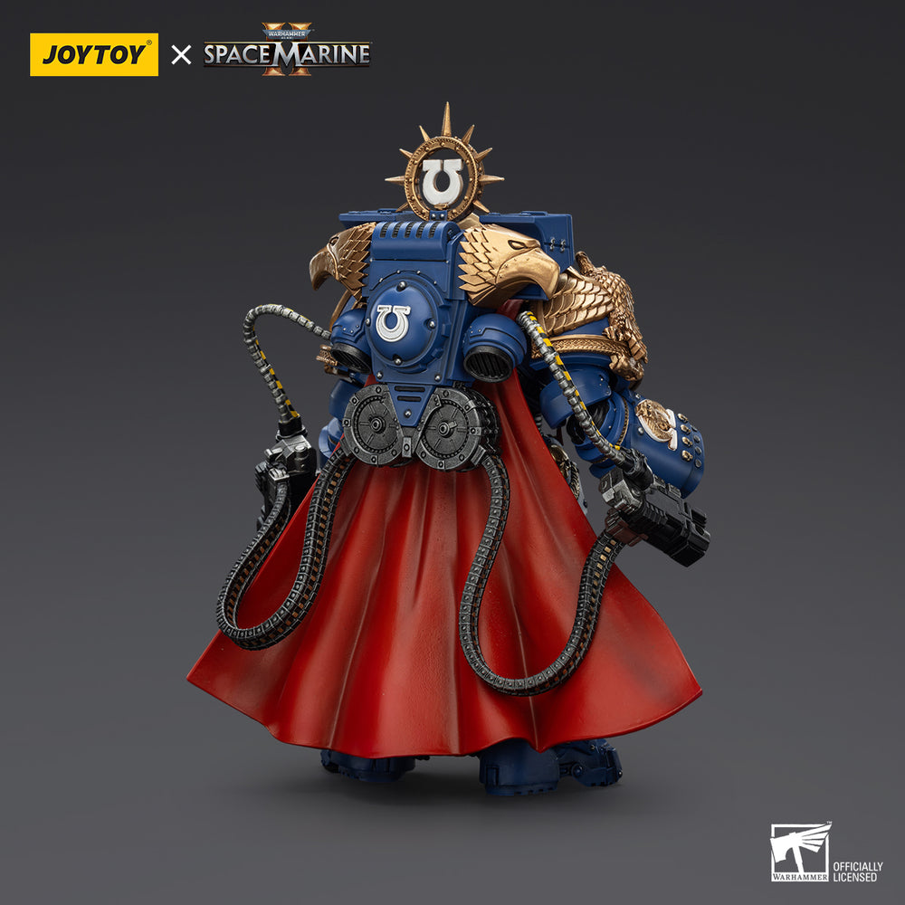 Rear view of a blue and gold Warhammer 40K Ultramarines Space Marine action figure wearing a flowing red cape