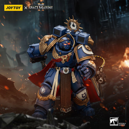 A detailed Ultramarine Captain figure in blue power armor, gold trim, and red cape, stands heroically in a fiery, war-torn ruin