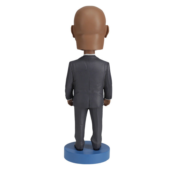 Royal Bobbles John Lewis bobblehead in a grey suit and blue tie back view
