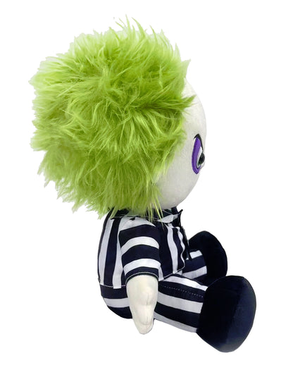 The seated Beetlejuice plush toy is seen in profile, wearing the classic black and white striped suit and sporting thick, bright lime-green hair