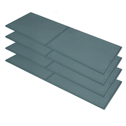 A stack of four dark gray rectangular tray with circular indentations