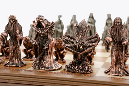 Close up of Dal Rossi Evil Ring Metal Chessmen, showing dark bronze fantasy figures like a wizard, a crowned hooded king, and a spider on a skull base on a chess board