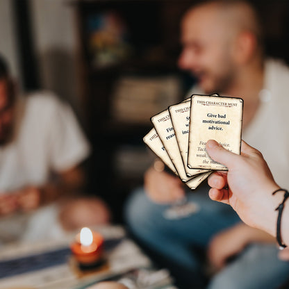 Hand holding game cards, featuring the prompt "Give bad motivational advice," during a dimly lit social game