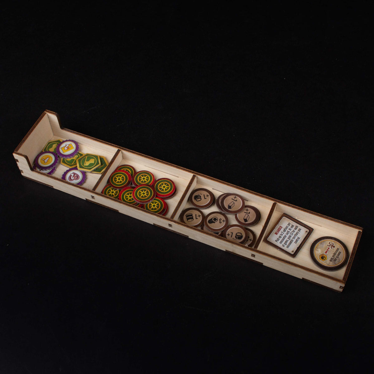 Insert with organized game pieces and cards