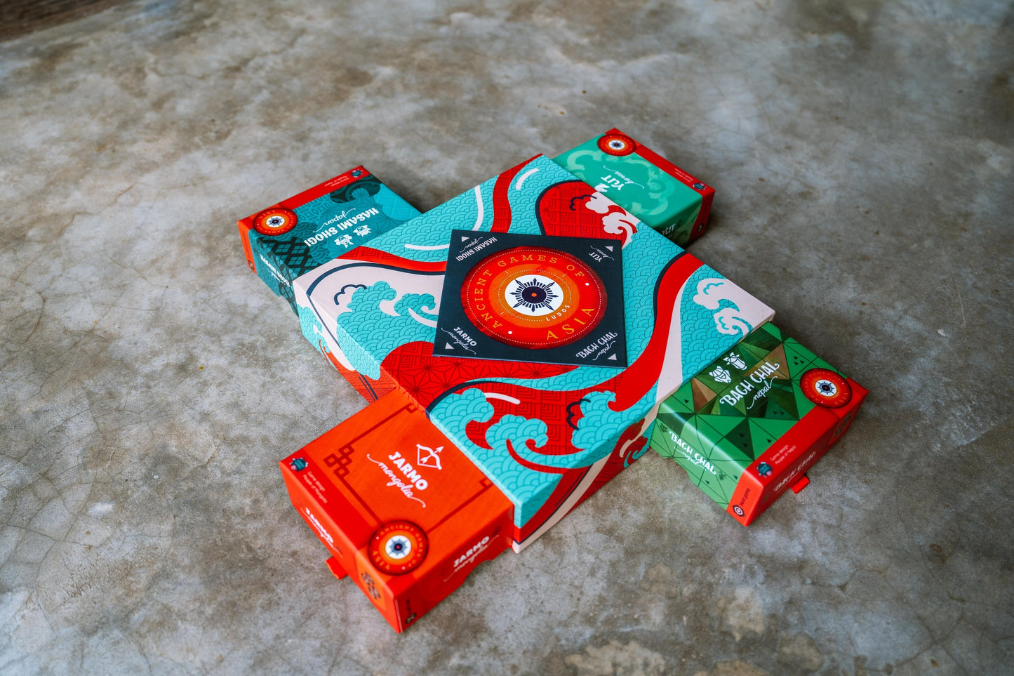Open LUDOS Asia collection box with all five games organized inside