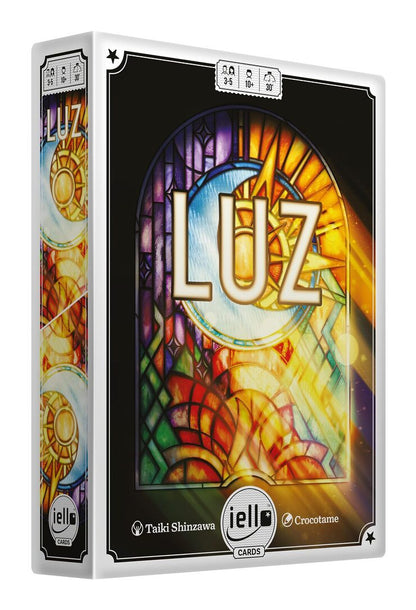 Luz card game box: vibrant stained glass art depicting a sun, moon, and the word 'LUZ'