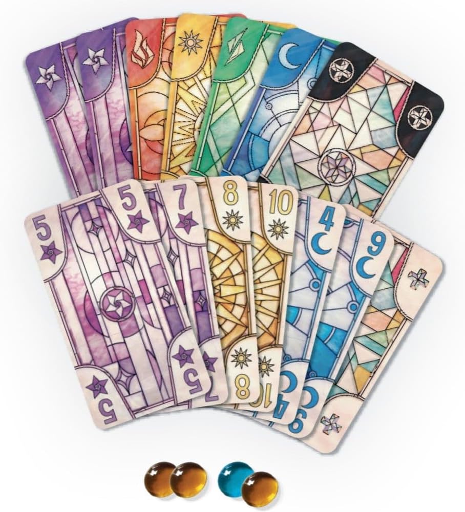 Fanned Luz game cards with colorful stained glass designs, numbers, and symbols. Five glass tokens are below