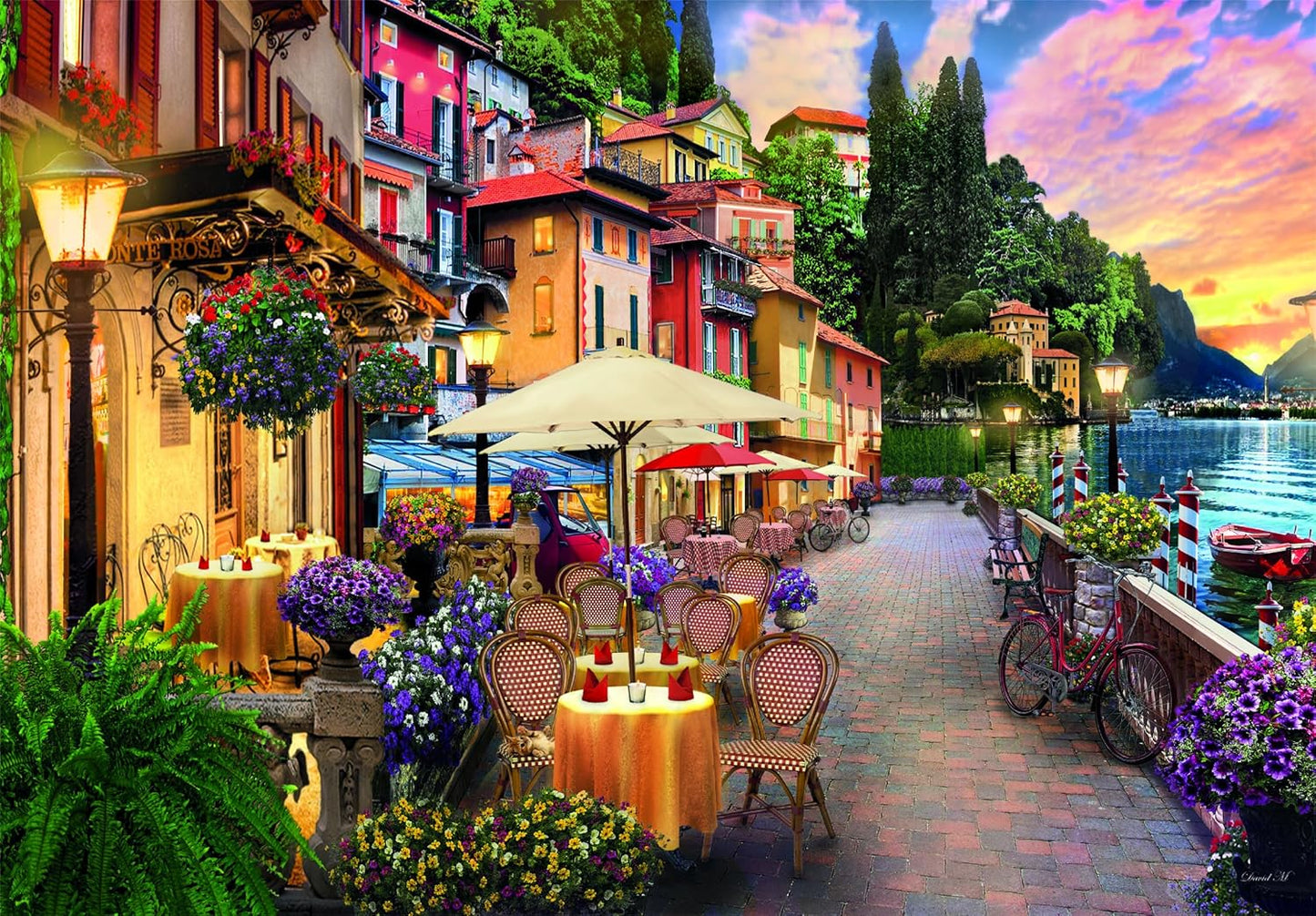 Colorful waterside village with an outdoor cafe, lush flowers, and a lake under a vibrant sunset sky.