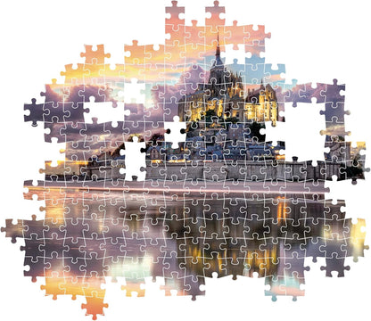 Partially assembled jigsaw puzzle showing Mont Saint-Michel illuminated at dusk, reflected in water