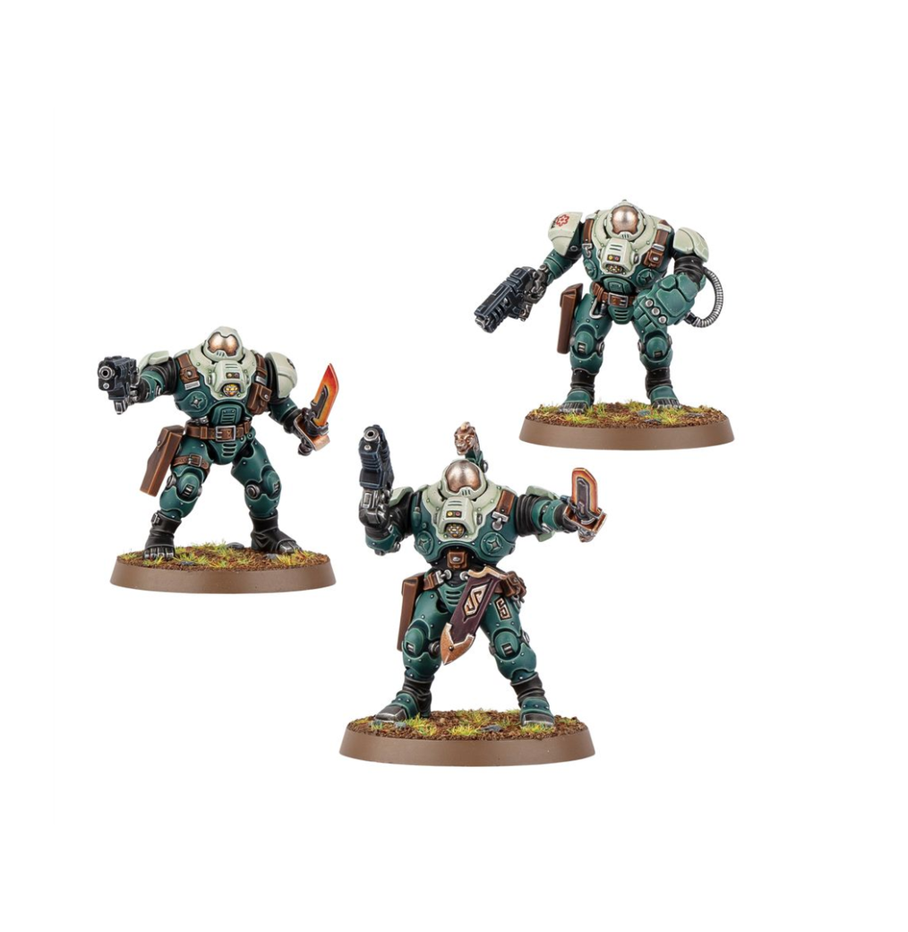 Three miniature sci-fi warriors in teal and white heavy armor, armed with pistols, a knife, and a handheld device, on bases