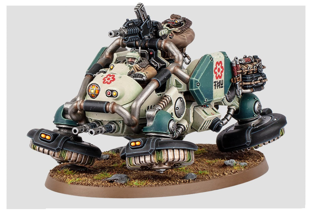 A cream and green sci-fi miniature battle walker with two crew, top-mounted cannon, front guns, and hover pads