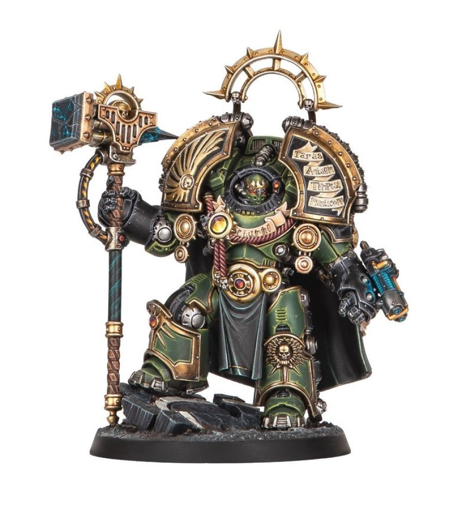 Ornate green and gold armored miniature warrior holding a glowing hammer and a gun, standing on a base