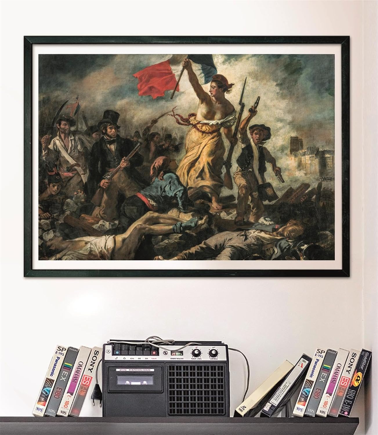Framed painting of Liberty Leading the People: A woman with a French flag leads armed revolutionaries over fallen bodies