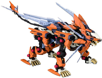 Orange and dark gray mechanical lion with prominent blades on its back, head, and tail, standing on gold-clawed feet