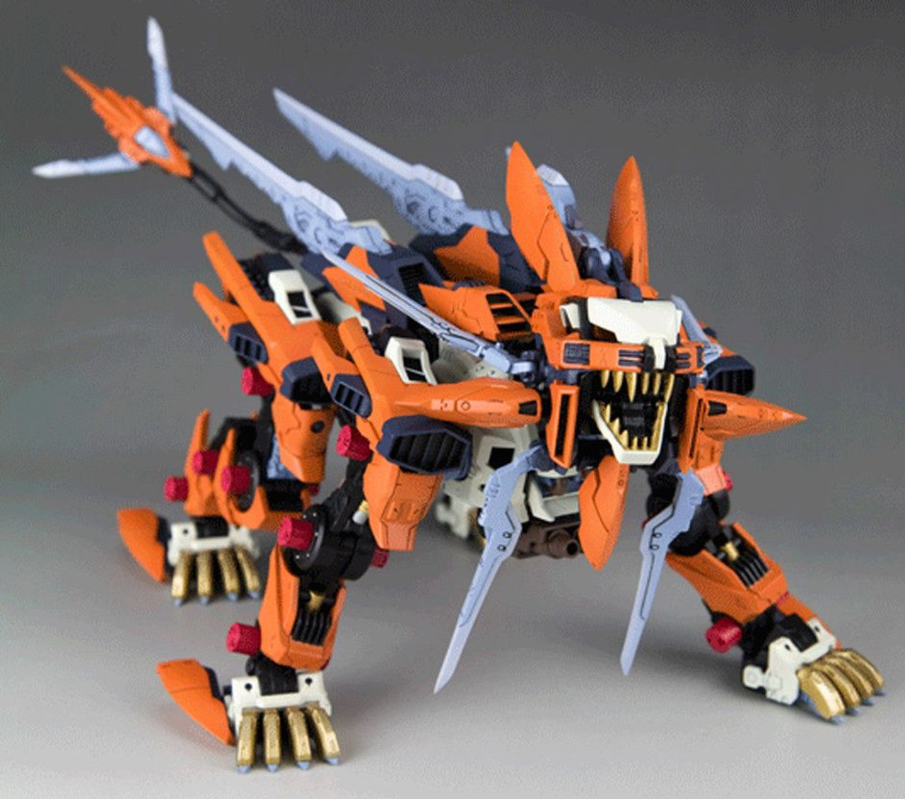 Orange and black Zoids Liger Zero model with sharp fangs and back blades, standing aggressively