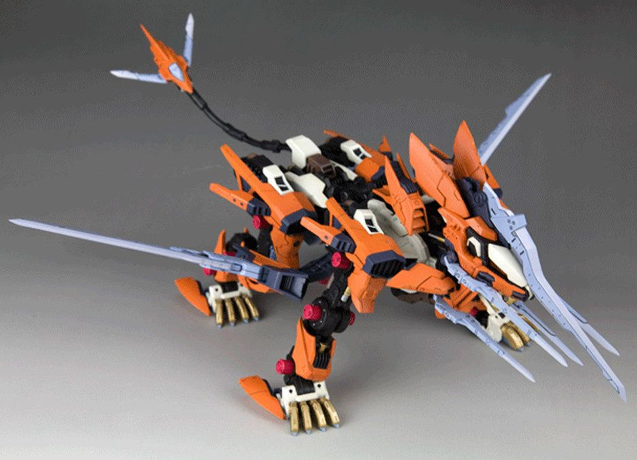 Orange, black, and white mechanical beast model with sharp blades, a segmented tail, and gold claws