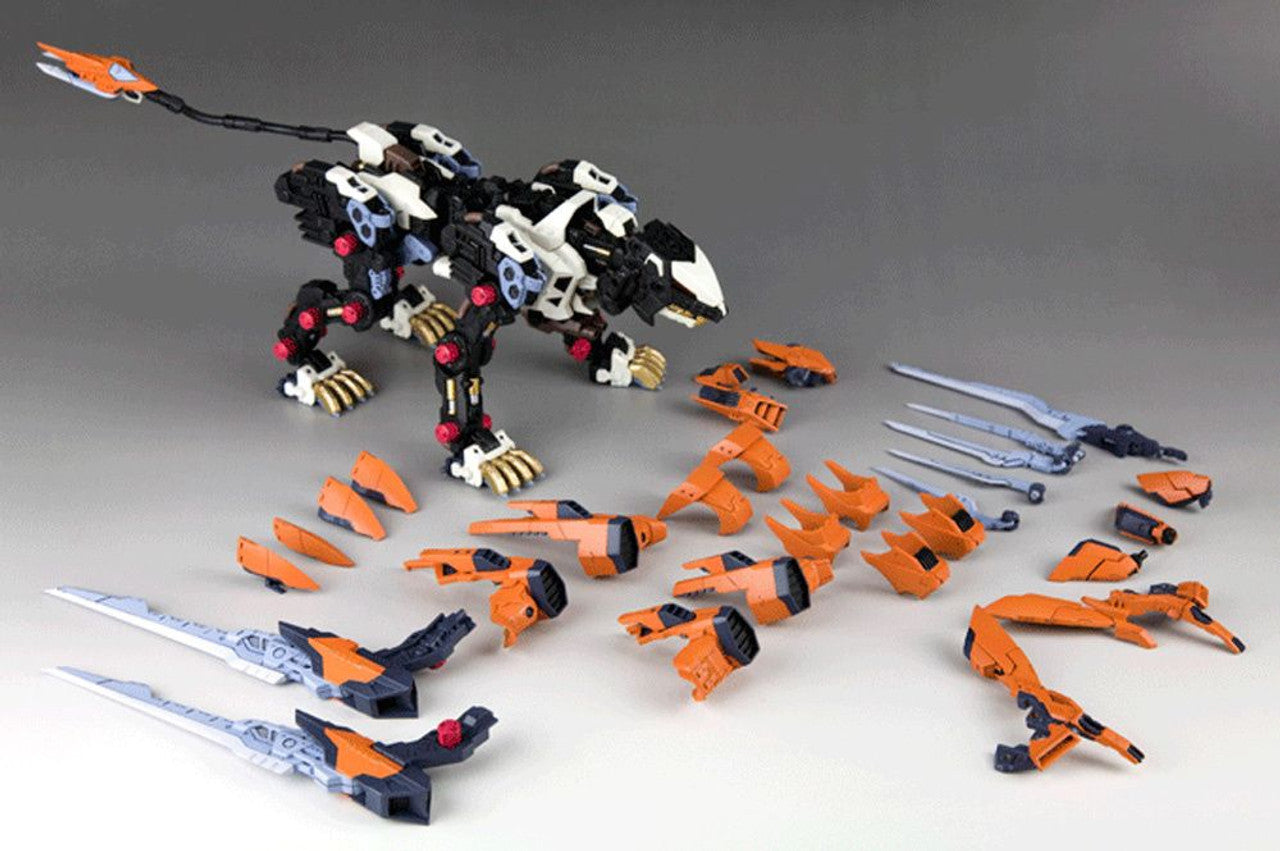 Partially assembled Zoid model kit: a black and white mechanical tiger surrounded by many unassembled parts