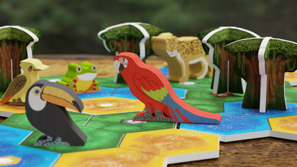 Bad Comet Life of the Amazonia board game meeple set, featuring wooden parrot, toucan, and frog figures on game tiles