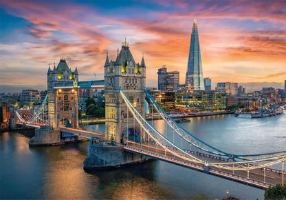 Illuminated Tower Bridge at dusk with The Shard and London skyline along the River Thames