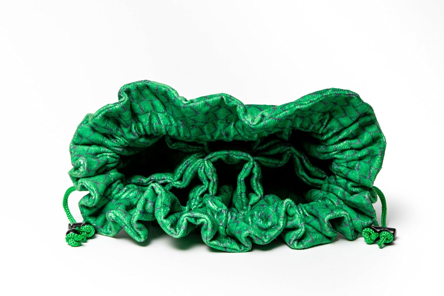 Open green drawstring dice bag with a quilted texture and internal compartments