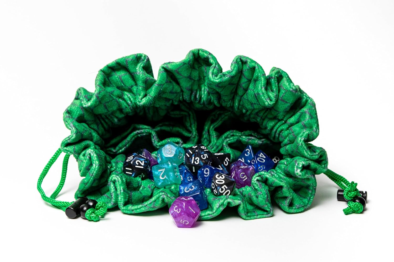 An open green dice bag holds a vibrant mix of polyhedral game dice on white