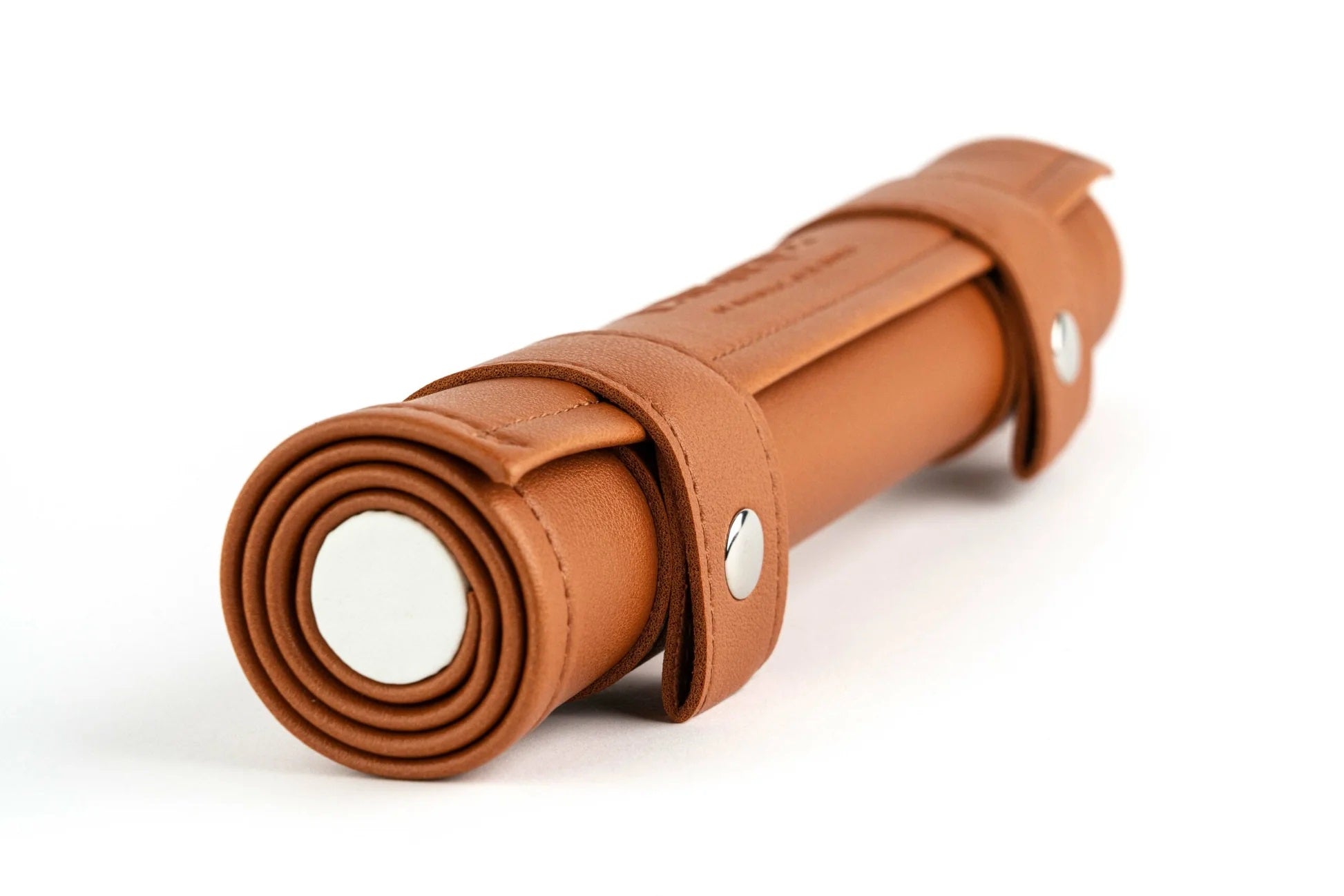 A brown leather roll with two straps and silver snaps on a white background