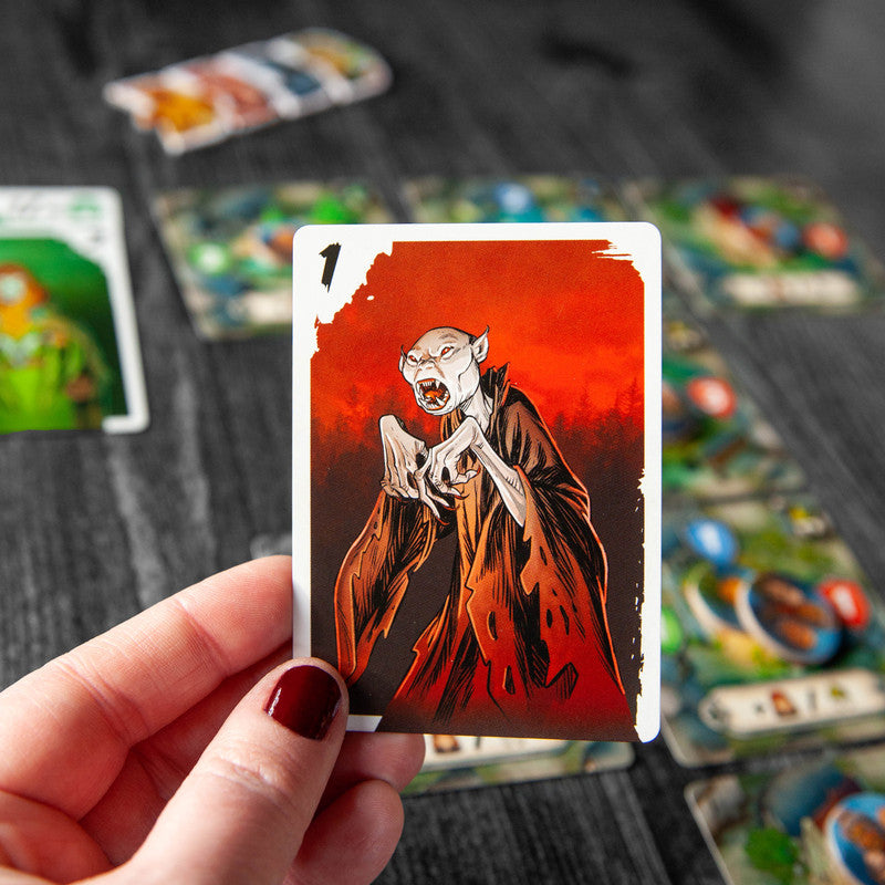 Tabletop view of players engaged in a game of Vampire Village