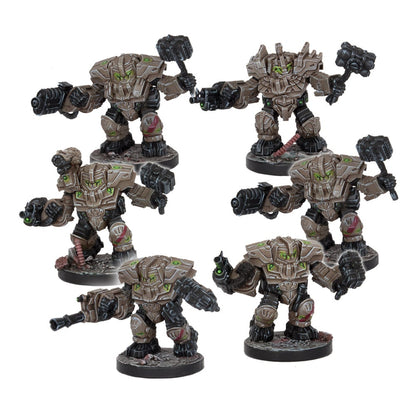 Six armored robot miniatures in tan and green, armed with hammers and guns, posed on bases.