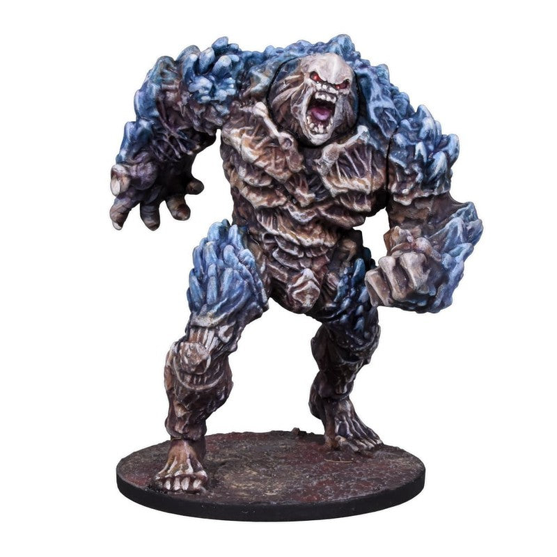A detailed miniature of a brown and blue-grey rock monster with jagged armor, an open, roaring mouth and glowing red eyes
