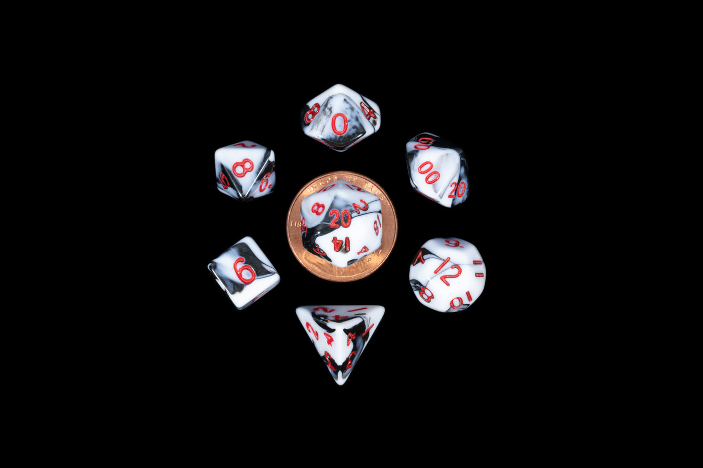 Marbled white and black polyhedral dice with red numbers surround a penny on a black background.