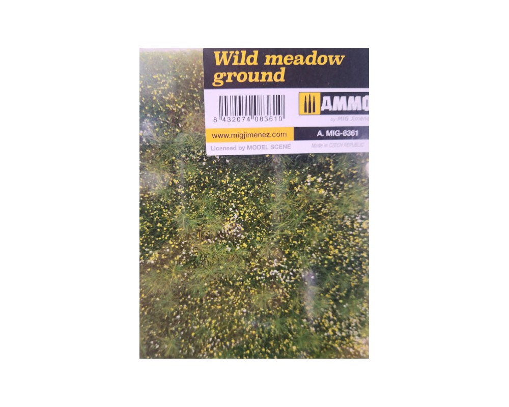 A "Wild meadow ground" model scenery product, featuring textured green grass with small yellow and white flowers.