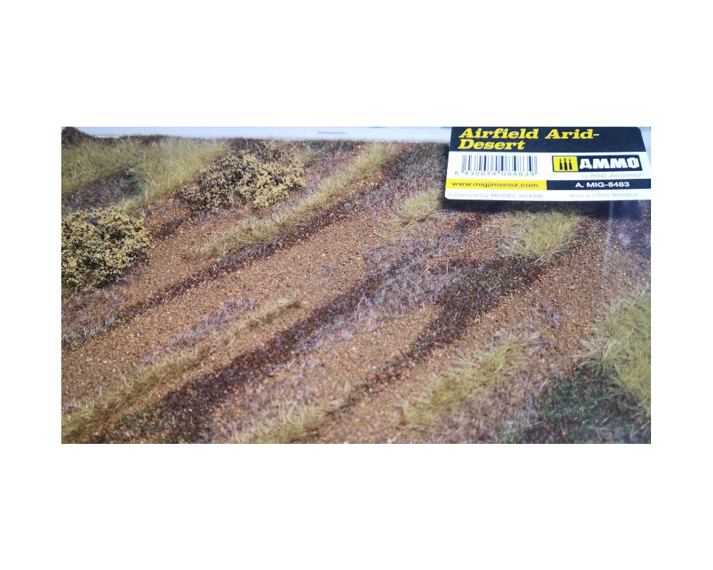 AMMO by MIG Airfield Arid-Desert model scenery mat shows sandy terrain with sparse dry grass and bushes.