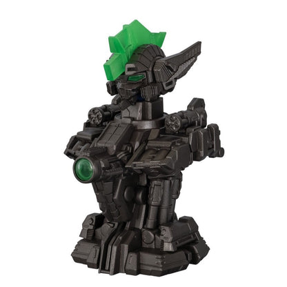 Dark gray robot figure with a green spiky crest, green eyes, a large green chest lens, and shoulder-mounted weapons