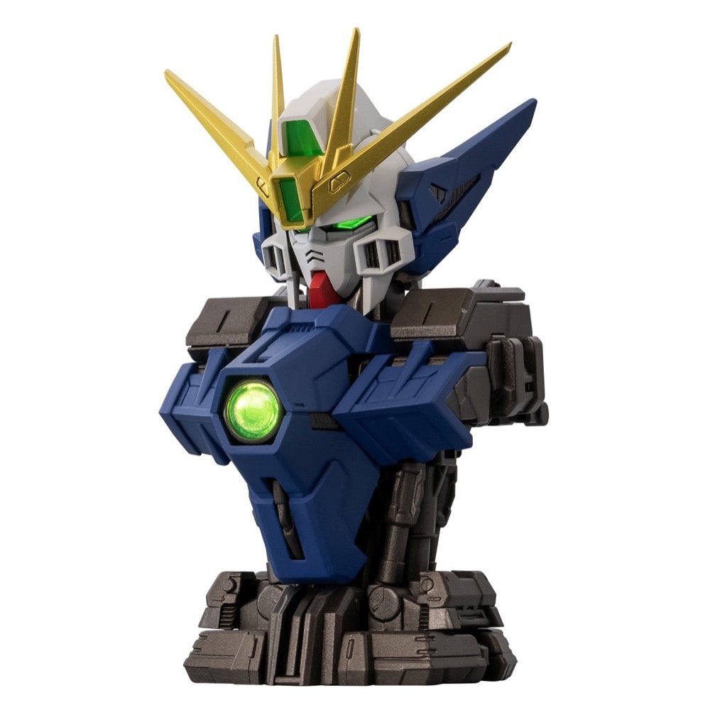 Blue and white Gundam robot bust with gold V-fin, glowing green eyes, and a green chest orb