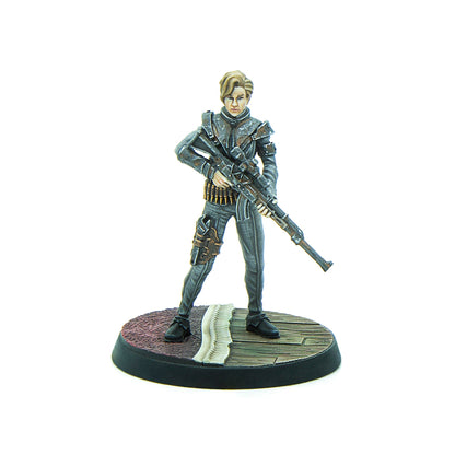 Painted miniature of a blonde woman in a grey tactical suit, holding a large sniper rifle across her chest