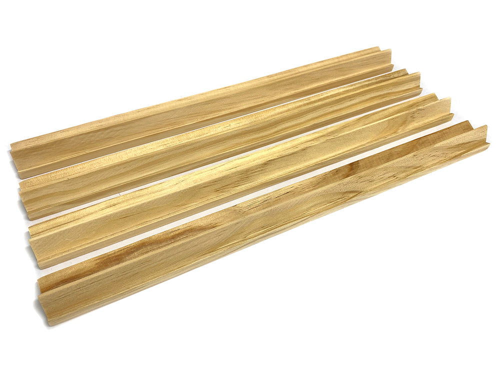 Four light wooden molding strips with a channel, fanned out on a white background