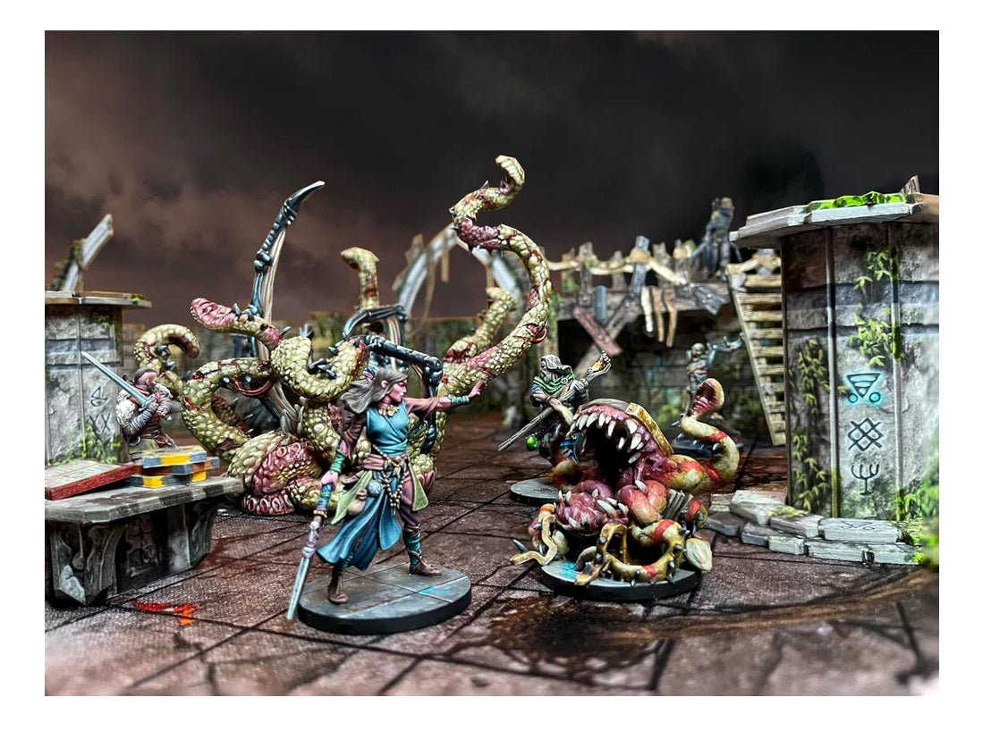 Painted miniatures: A female fantasy character with a sword and outstretched hand confronts a huge tentacled monster in ruins.