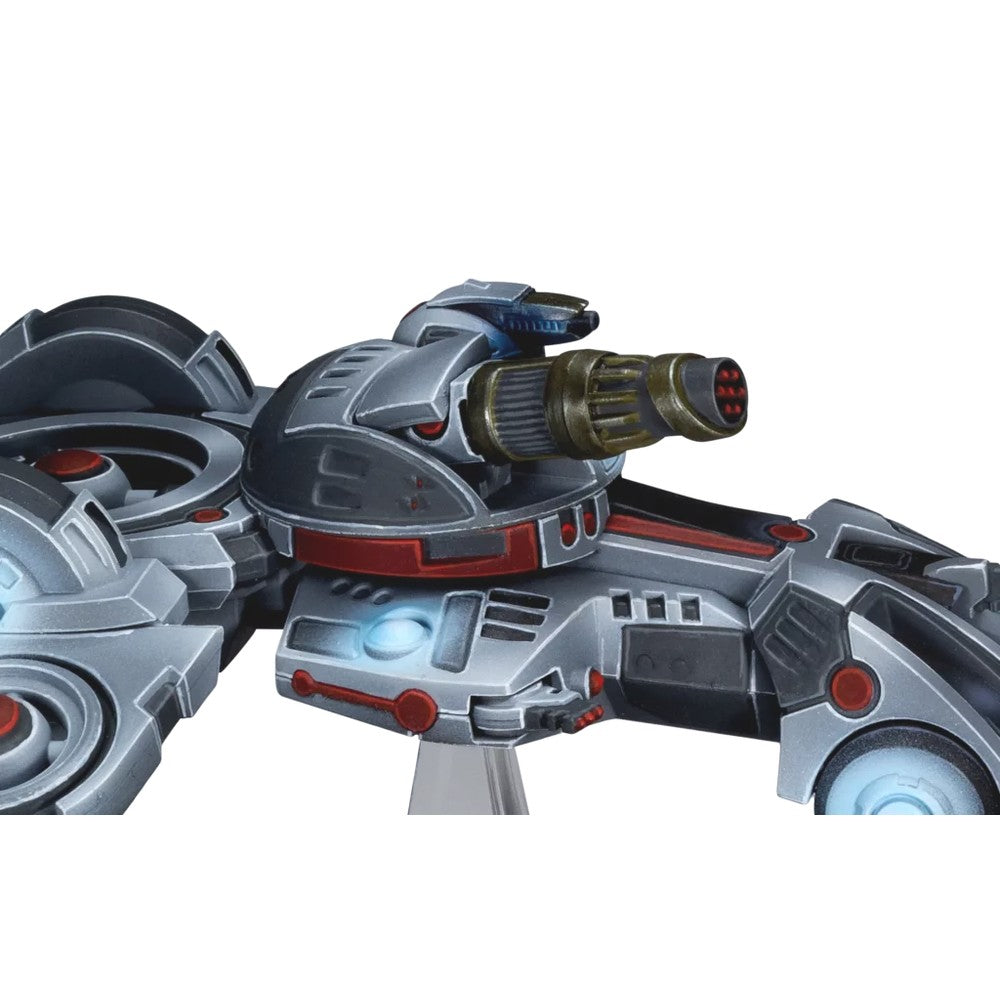 A grey and red miniature sci-fi combat vehicle model with a large multi-barreled cannon and glowing blue lights
